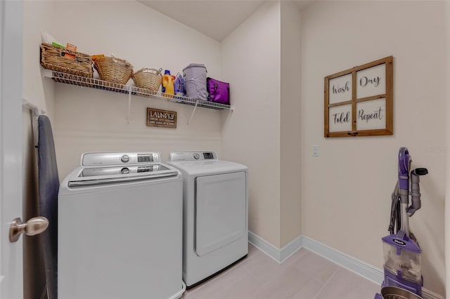 laundry room featuring light tile patterned floors and washer and dryer