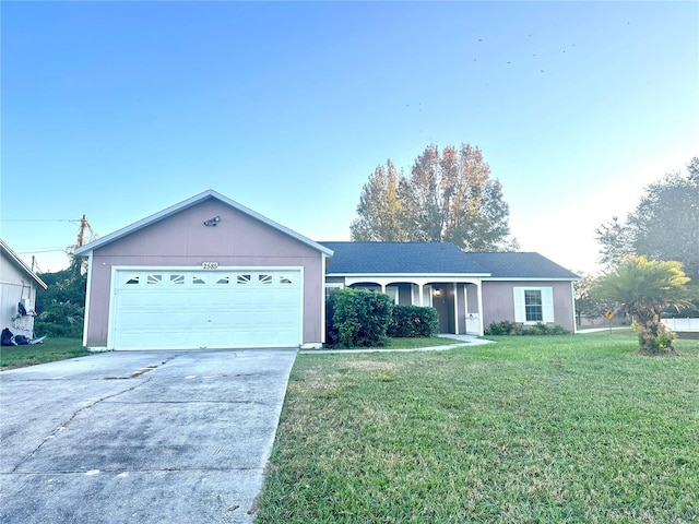 ranch-style house featuring a front lawn and a garage