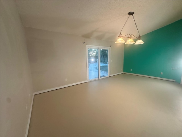 spare room featuring a textured ceiling and concrete floors