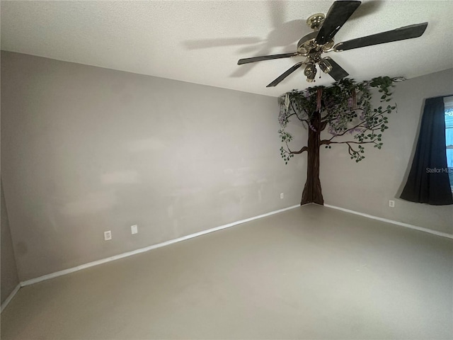 unfurnished room with a textured ceiling, concrete floors, and ceiling fan