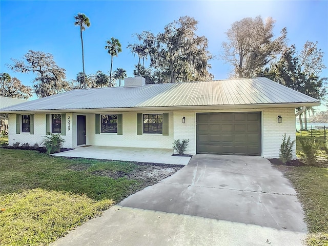 single story home with a front lawn, covered porch, and a garage