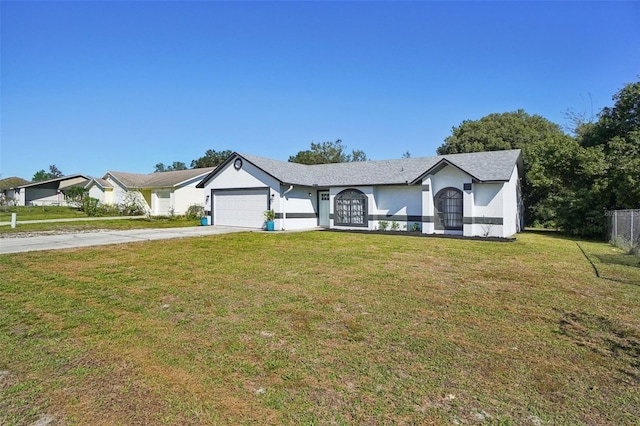 view of front of house featuring a garage and a front lawn