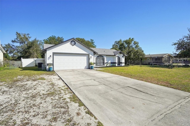 single story home with a trampoline, a garage, and a front lawn