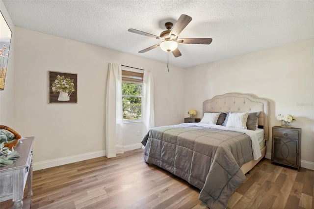 bedroom featuring a textured ceiling, hardwood / wood-style flooring, and ceiling fan