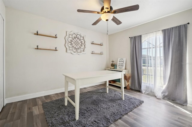 home office featuring hardwood / wood-style floors and ceiling fan