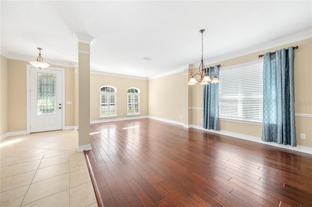 interior space with light hardwood / wood-style floors, crown molding, and a notable chandelier