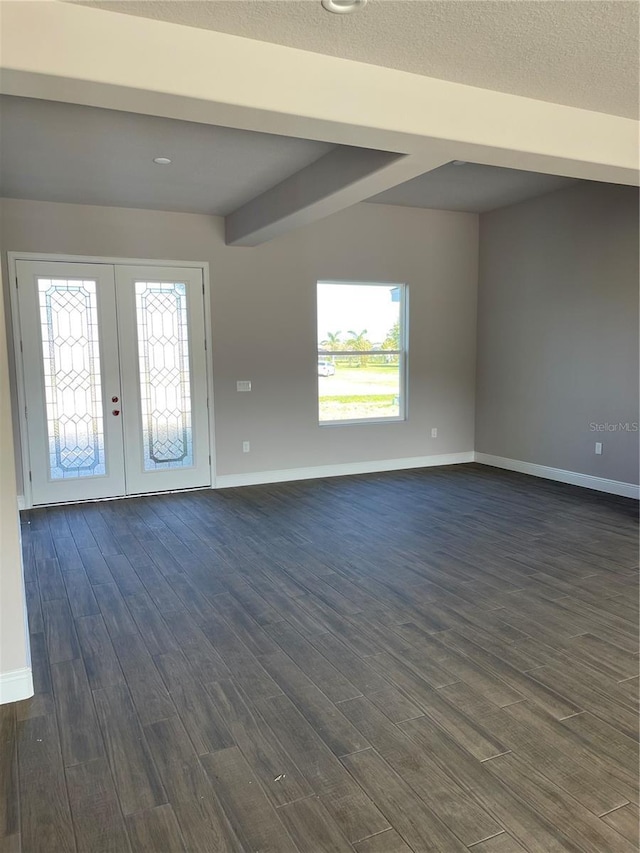 empty room with dark wood-type flooring and french doors