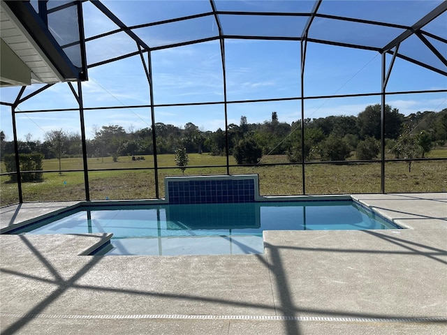 view of swimming pool with a patio, glass enclosure, and a lawn