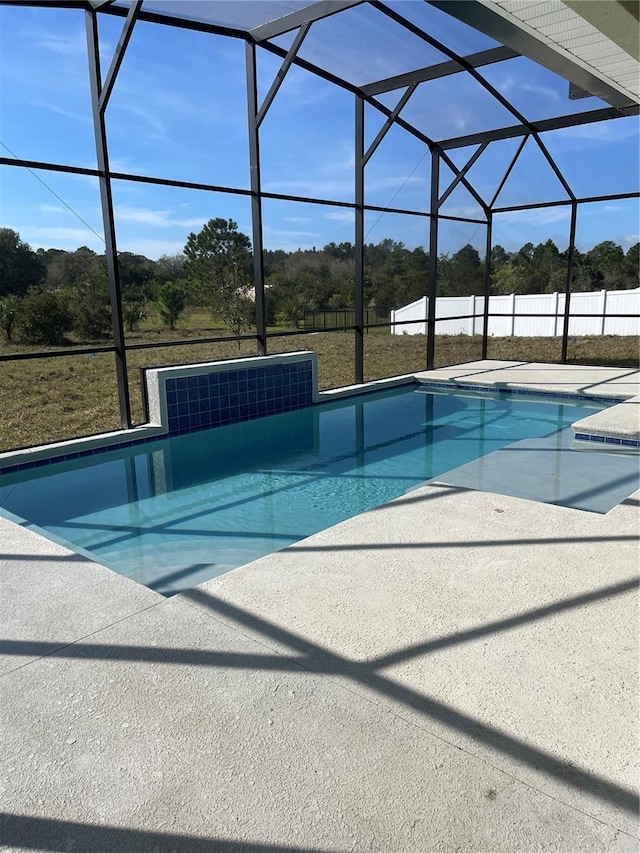 view of pool featuring a patio area and glass enclosure