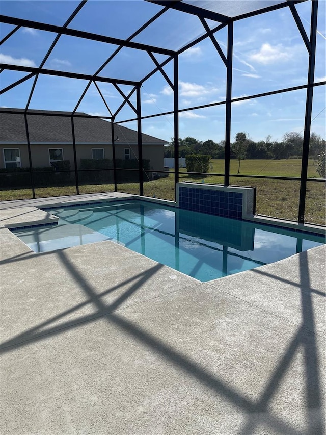 view of swimming pool with a yard, a lanai, and a patio