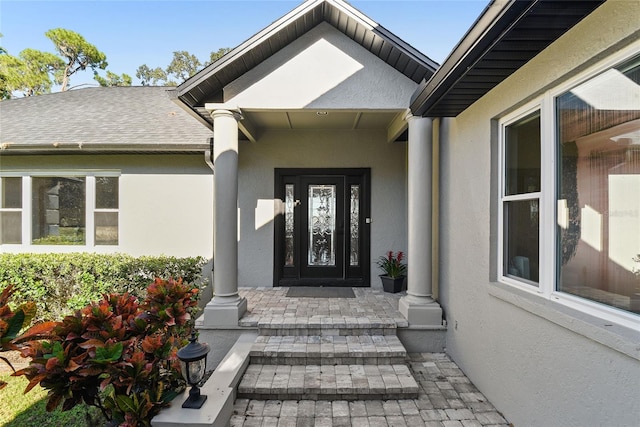 view of exterior entry with a porch