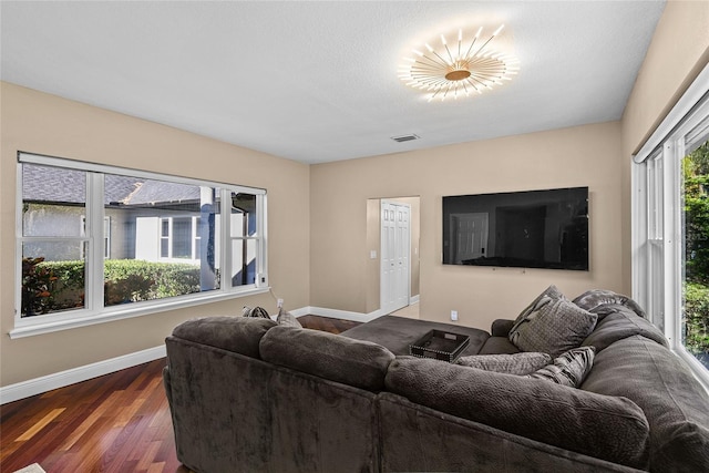 living room featuring dark hardwood / wood-style floors and a textured ceiling