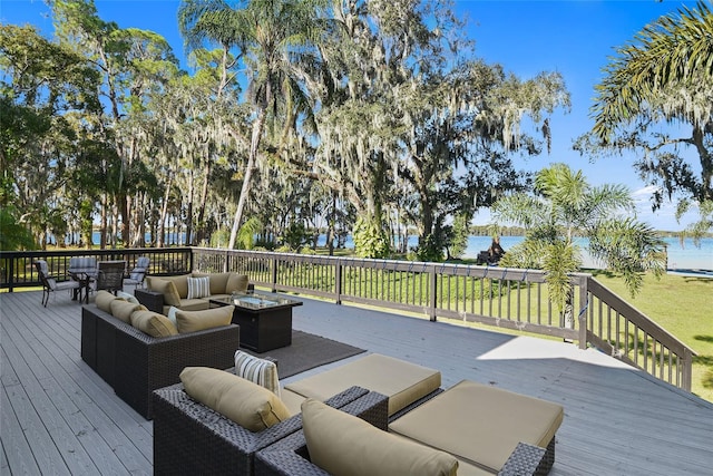 wooden terrace featuring outdoor lounge area and a yard