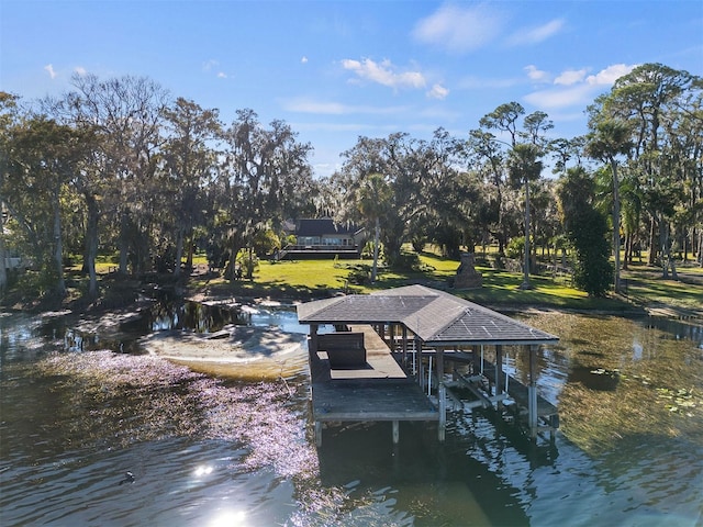 dock area with a water view and a lawn