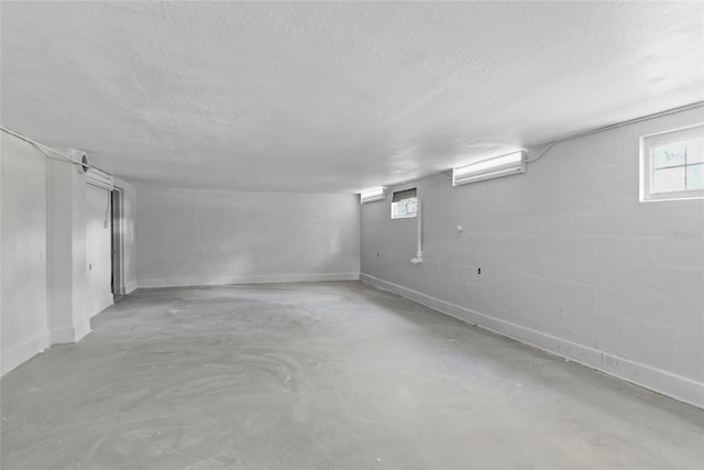 basement featuring a textured ceiling