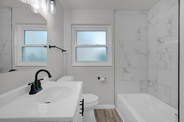 full bathroom featuring wood-type flooring, vanity, toilet, and a wealth of natural light