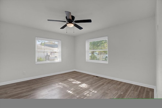 spare room with hardwood / wood-style flooring and ceiling fan