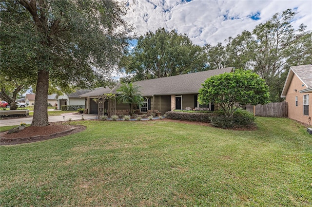 ranch-style house featuring a garage and a front yard