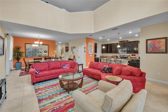 living room featuring light tile patterned floors, a towering ceiling, an inviting chandelier, and crown molding