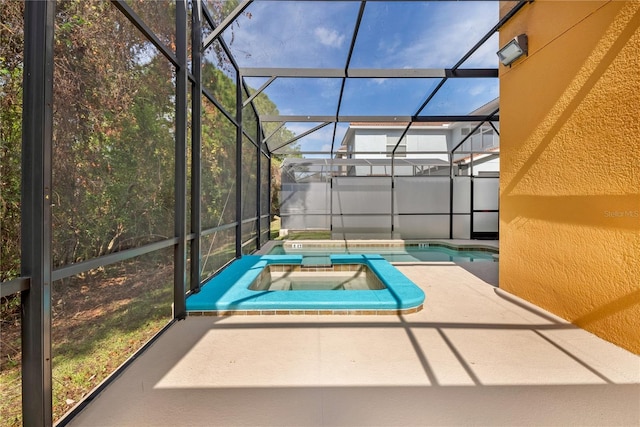 view of pool featuring glass enclosure, an in ground hot tub, and a patio