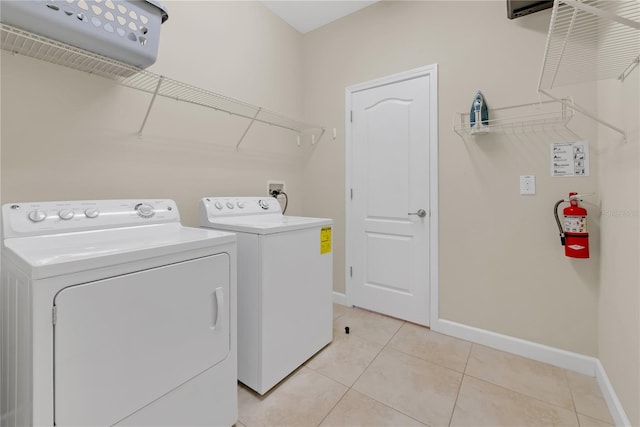 laundry room featuring light tile patterned floors and washer and dryer