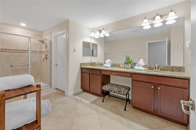 bathroom with tile patterned flooring, vanity, and walk in shower