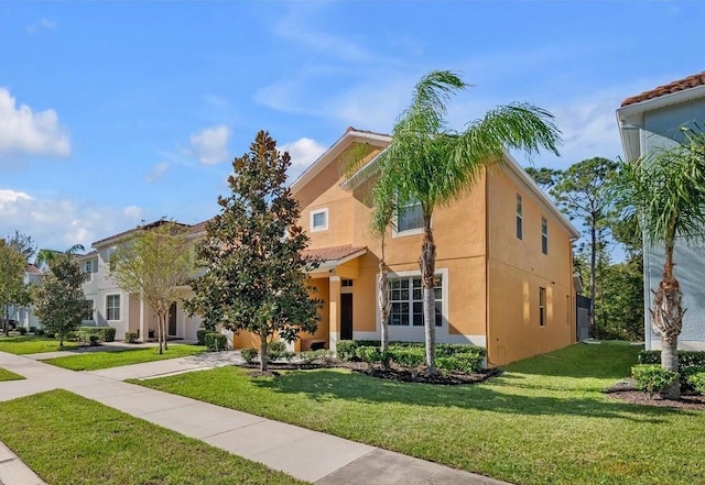 mediterranean / spanish-style home with a front yard