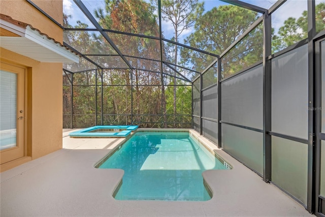 view of pool featuring glass enclosure, an in ground hot tub, and a patio