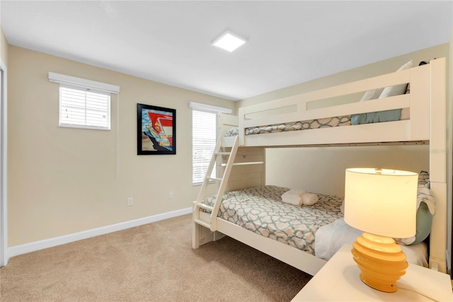 carpeted bedroom featuring multiple windows