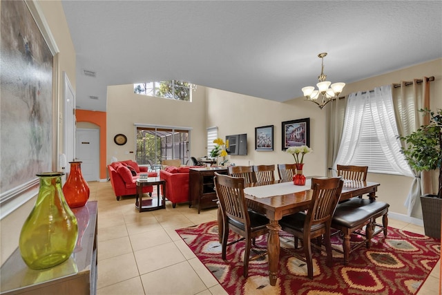 tiled dining space featuring vaulted ceiling and a notable chandelier