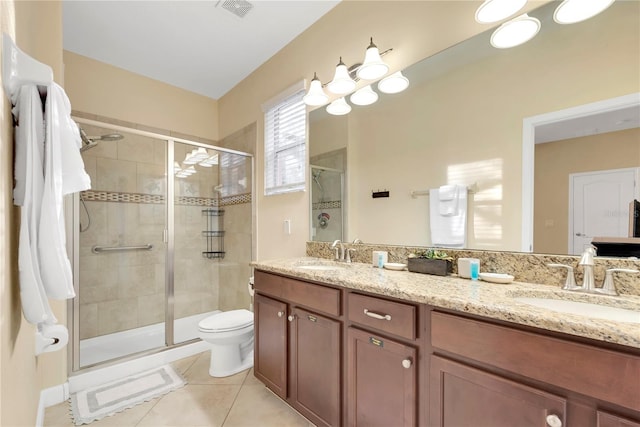 bathroom featuring tile patterned flooring, vanity, toilet, and walk in shower