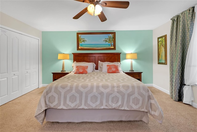 carpeted bedroom featuring ceiling fan and a closet