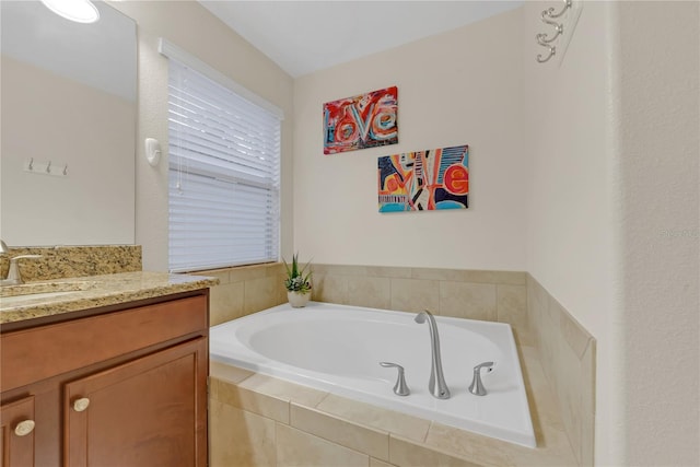 bathroom featuring vanity and tiled tub