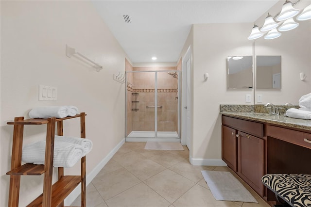 bathroom with tile patterned floors, vanity, and walk in shower