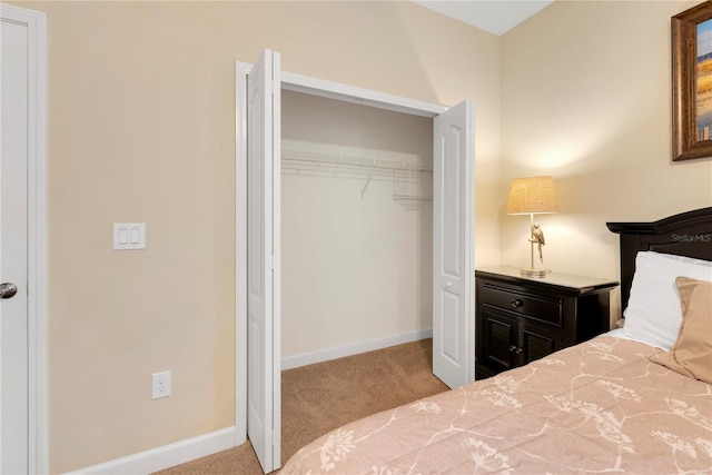 unfurnished bedroom featuring light colored carpet and a closet