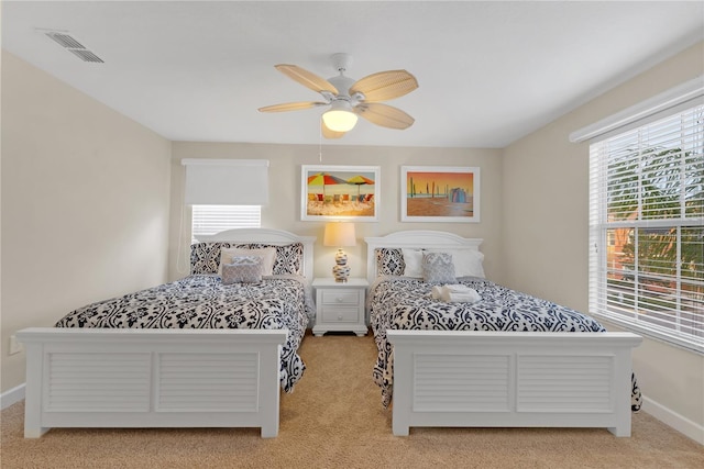 bedroom featuring ceiling fan and light colored carpet