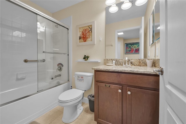 full bathroom featuring combined bath / shower with glass door, vanity, tile patterned floors, and toilet