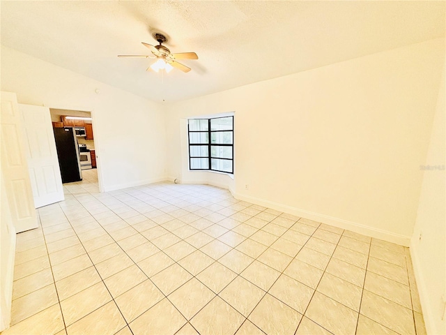 unfurnished room featuring light tile patterned floors, a textured ceiling, ceiling fan, and lofted ceiling