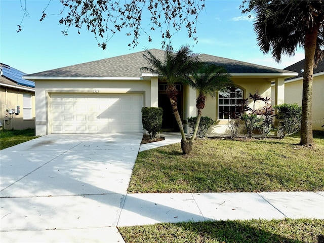 single story home with a front yard and a garage