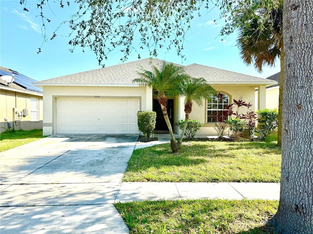 ranch-style house featuring a garage and a front yard