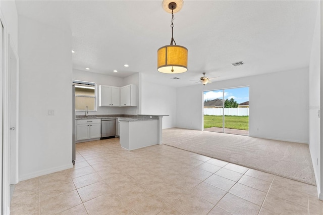 kitchen with ceiling fan, dishwasher, white cabinetry, hanging light fixtures, and light tile patterned floors