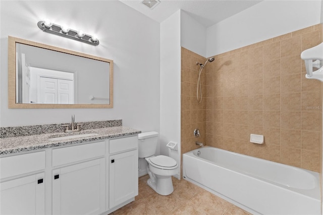 full bathroom featuring toilet, tiled shower / bath, tile patterned floors, and vanity