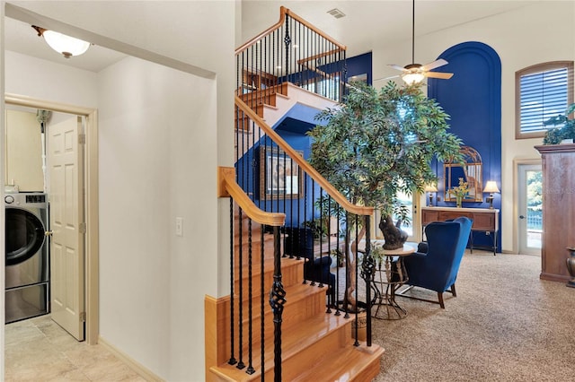 staircase featuring carpet flooring, washer / clothes dryer, and ceiling fan