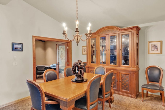 dining area featuring a chandelier, light colored carpet, and lofted ceiling