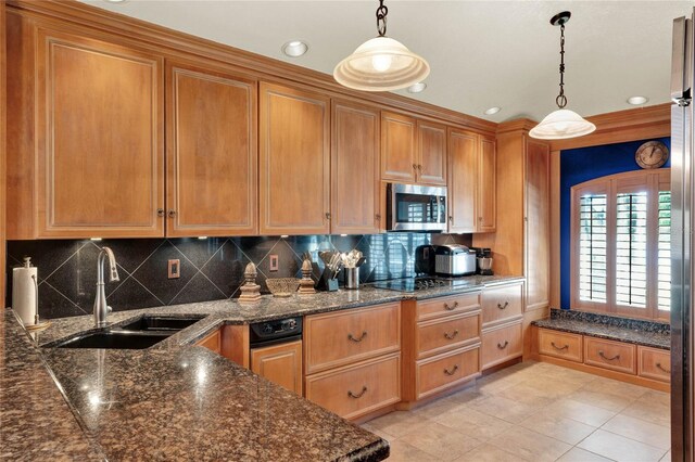 kitchen featuring sink, hanging light fixtures, backsplash, black stovetop, and light tile patterned floors