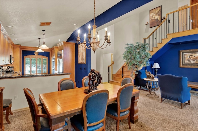 dining area featuring light carpet, a chandelier, and vaulted ceiling