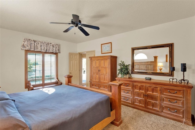 bedroom with ceiling fan, light carpet, and a textured ceiling