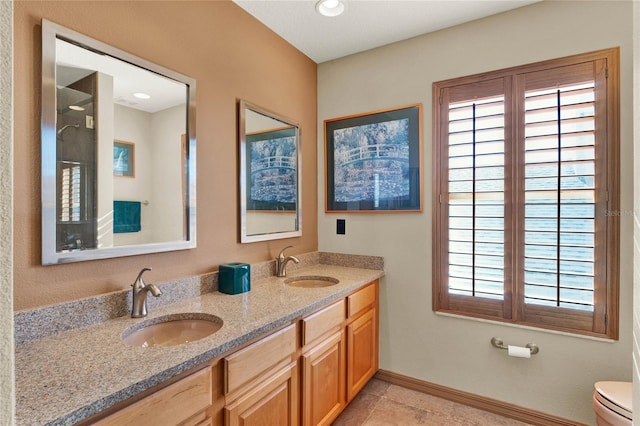 bathroom with tile patterned flooring, vanity, and toilet