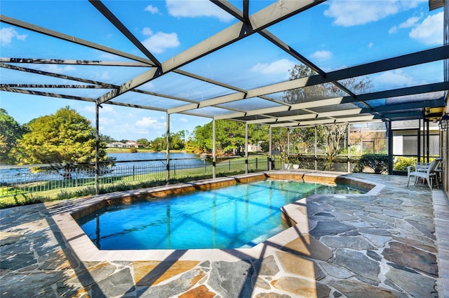 view of swimming pool featuring glass enclosure, a patio area, and a water view