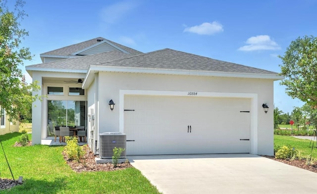 exterior space with central AC, ceiling fan, a front yard, and a garage